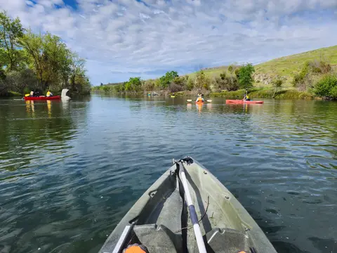 View from a kayak looking downstream at fellow paddlers